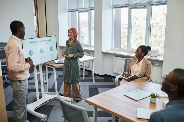 Multicultural team having a business presentation in a modern office setting. Inbound lead routing