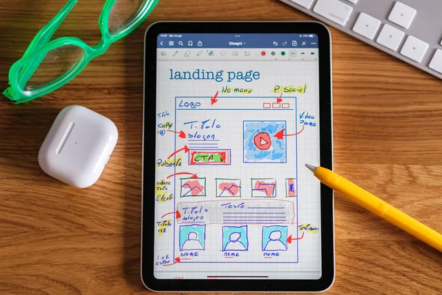 Close-up of tablet showing a hand-drawn landing page design, ideal for web development concepts. Lead generation landing pages